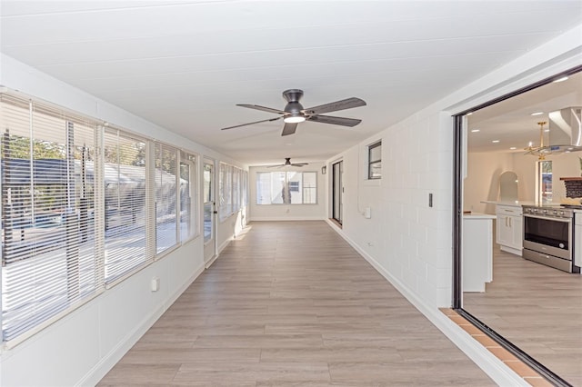 unfurnished sunroom featuring plenty of natural light and an inviting chandelier