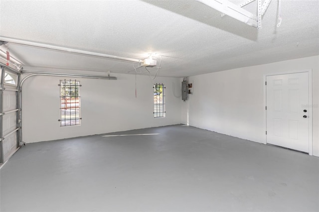 garage with electric panel and a garage door opener