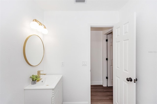 bathroom with vanity and hardwood / wood-style flooring