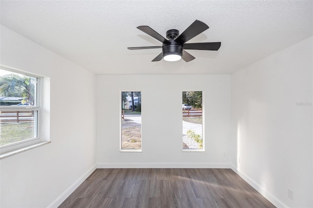 empty room featuring a textured ceiling, ceiling fan, and dark hardwood / wood-style flooring