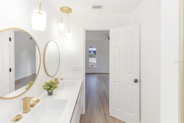 bathroom featuring ceiling fan, wood-type flooring, and vanity