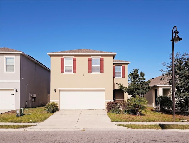 view of front property featuring a front yard and a garage