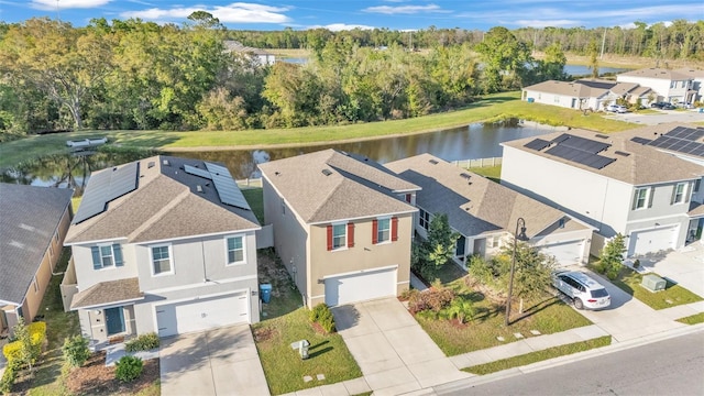 birds eye view of property with a residential view and a water view