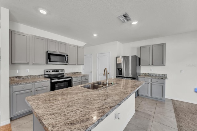 kitchen with gray cabinetry, appliances with stainless steel finishes, and a sink