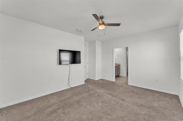 unfurnished living room featuring visible vents, baseboards, light colored carpet, and a ceiling fan