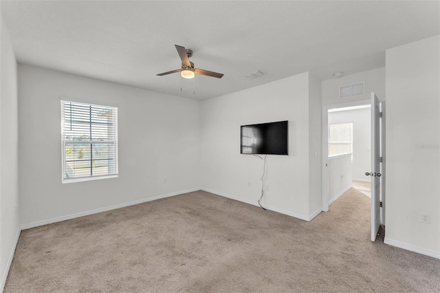 interior space with visible vents, baseboards, and ceiling fan