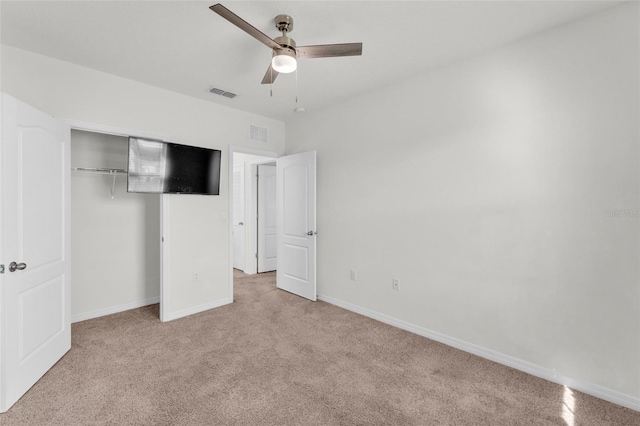 unfurnished bedroom with a closet, visible vents, baseboards, and carpet floors