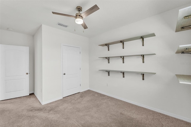 unfurnished bedroom featuring visible vents, carpet floors, baseboards, and ceiling fan