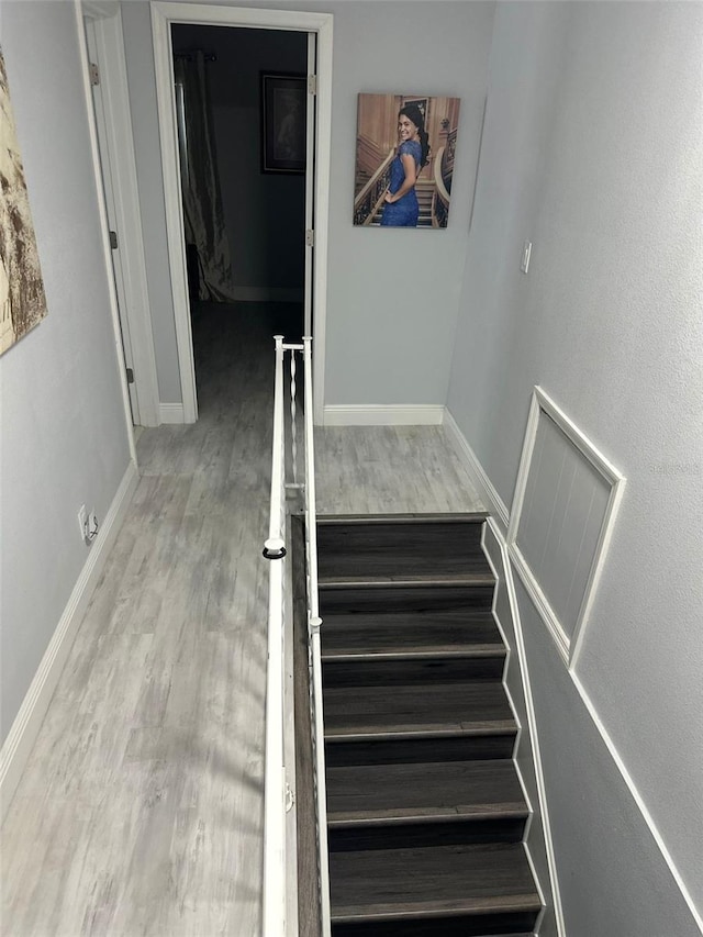 stairs with hardwood / wood-style flooring