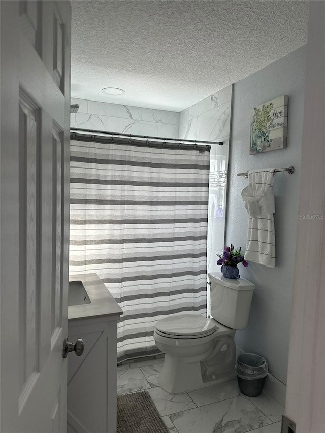 bathroom with vanity, a textured ceiling, a shower with curtain, and toilet