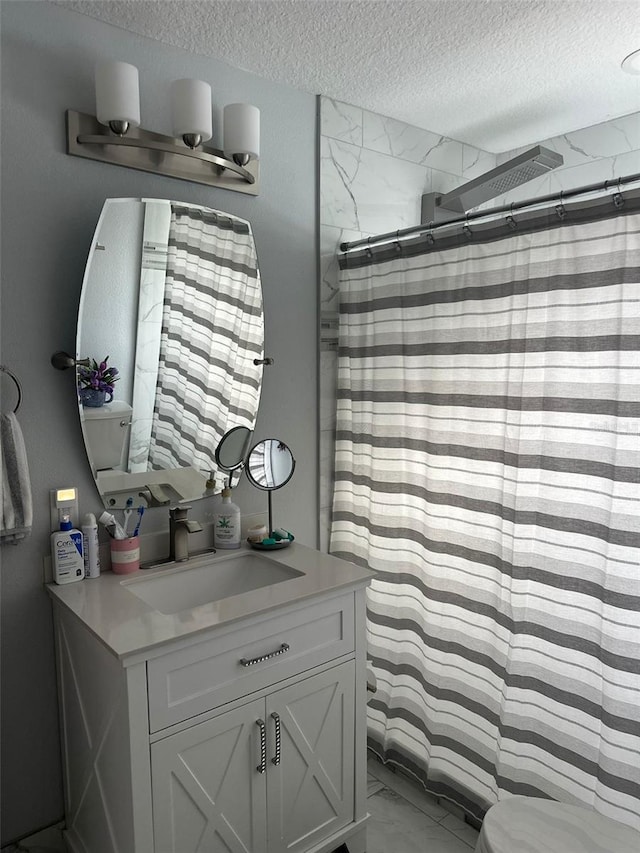 bathroom featuring vanity, toilet, a shower with shower curtain, and a textured ceiling