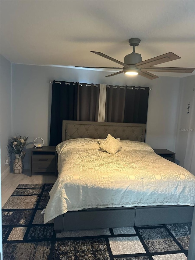 bedroom with ceiling fan and wood-type flooring