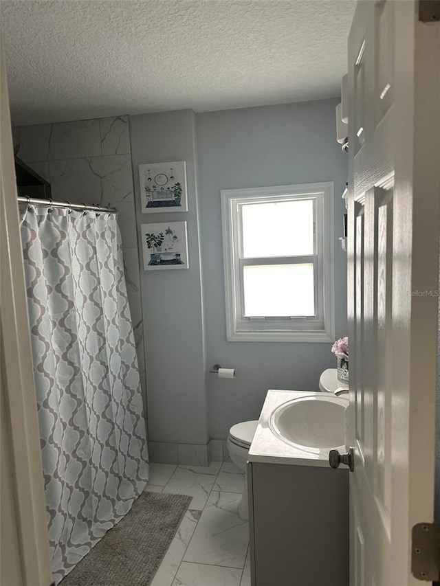 bathroom with vanity, toilet, a textured ceiling, and a shower with shower curtain