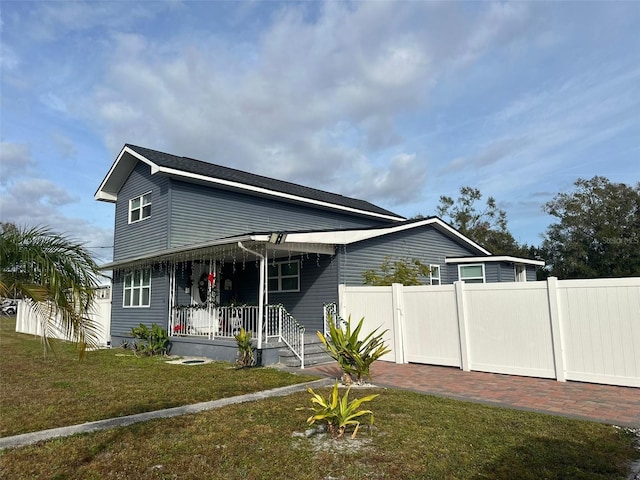 view of front of property with a porch and a front yard