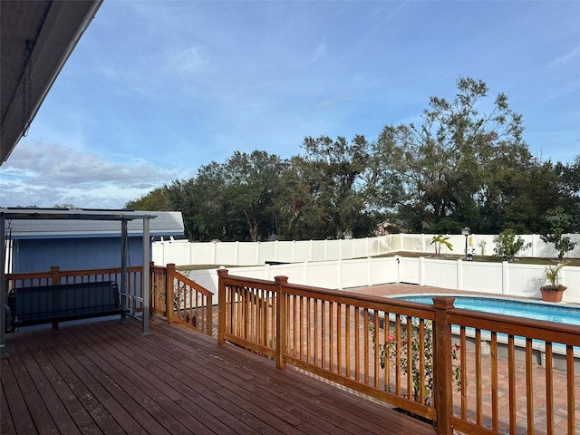 wooden terrace with a fenced in pool