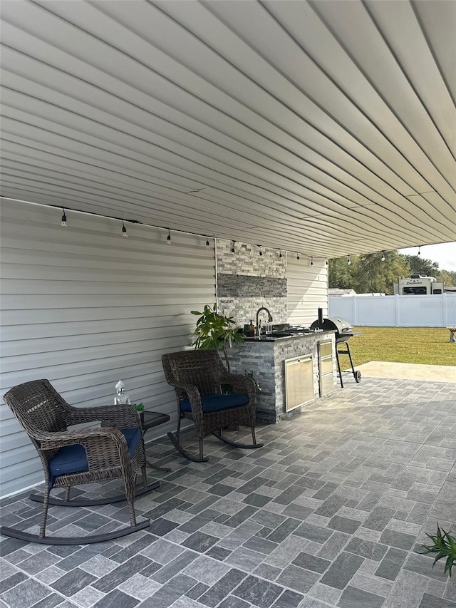 view of patio featuring exterior kitchen and sink