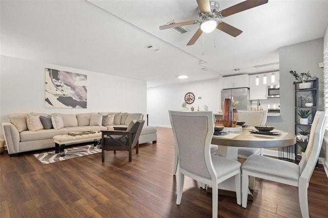 dining room with ceiling fan and dark hardwood / wood-style flooring