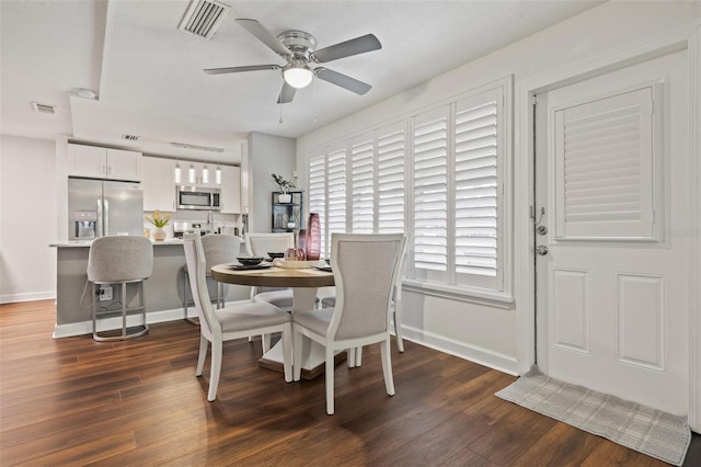 dining area featuring ceiling fan and dark wood-type flooring