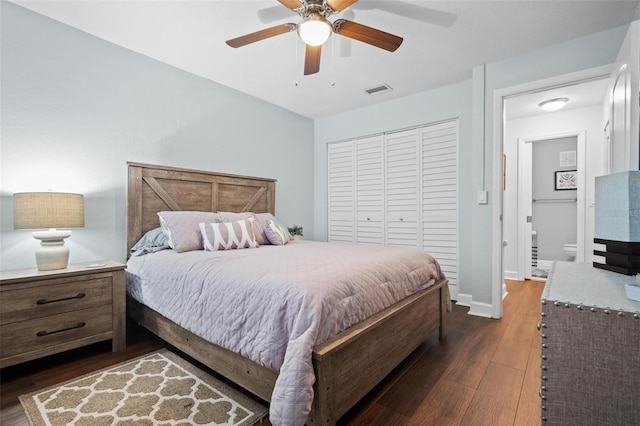 bedroom featuring ceiling fan, dark hardwood / wood-style flooring, a closet, and ensuite bath