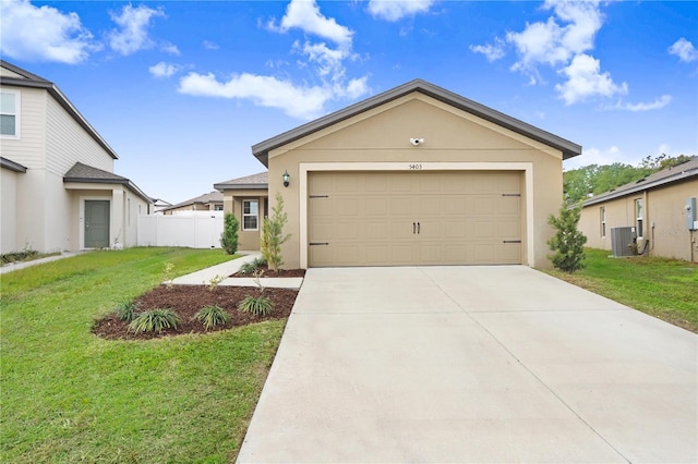 view of front of house with central AC unit, a front lawn, and a garage