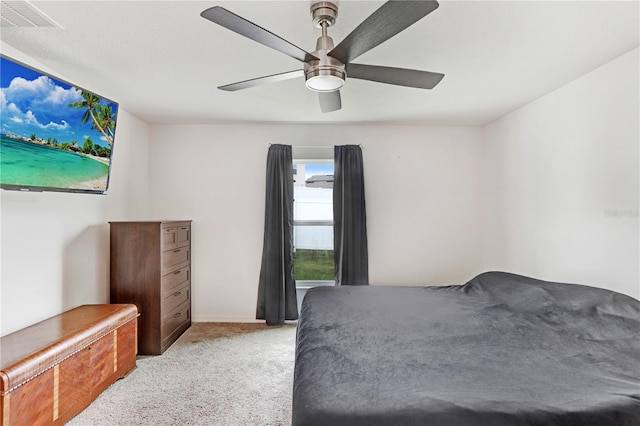 bedroom featuring light carpet and ceiling fan