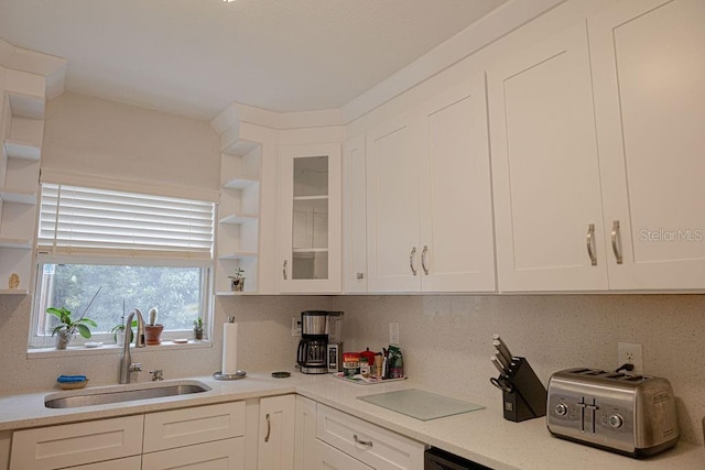 kitchen featuring sink and white cabinets