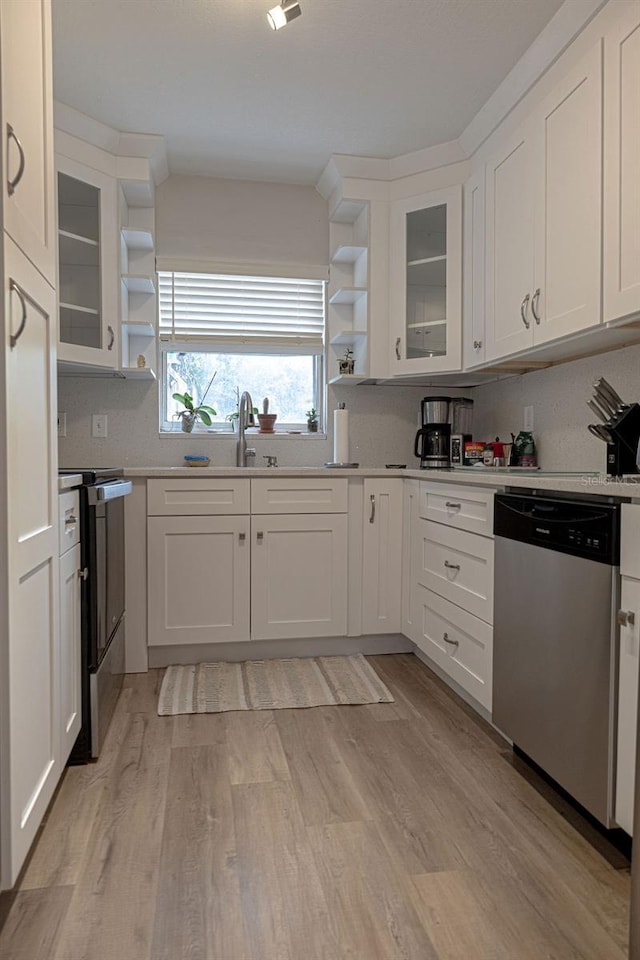 kitchen featuring appliances with stainless steel finishes, sink, light hardwood / wood-style floors, and white cabinets