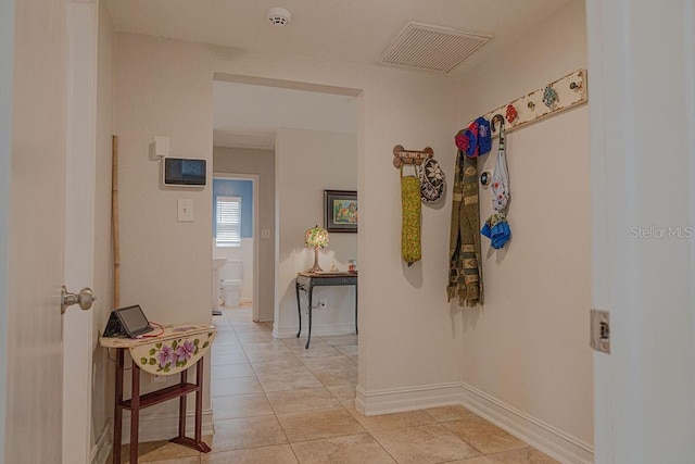 corridor with light tile patterned floors