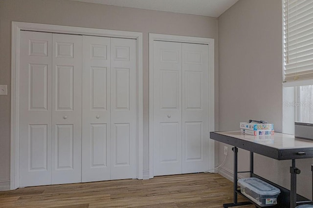 home office with light hardwood / wood-style flooring