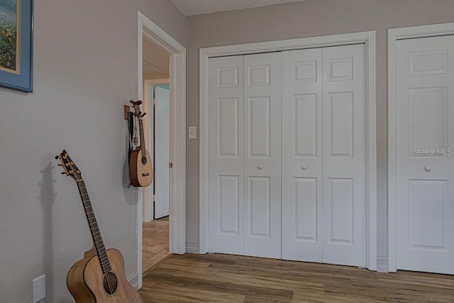 corridor with light hardwood / wood-style floors