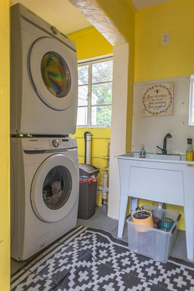 laundry area featuring stacked washing maching and dryer