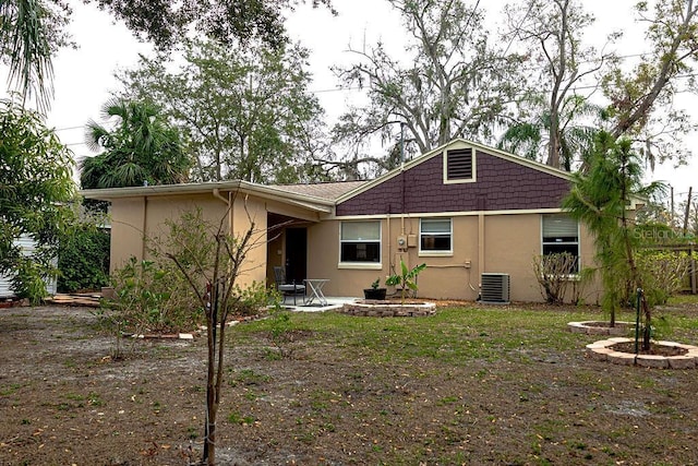 rear view of house with central air condition unit