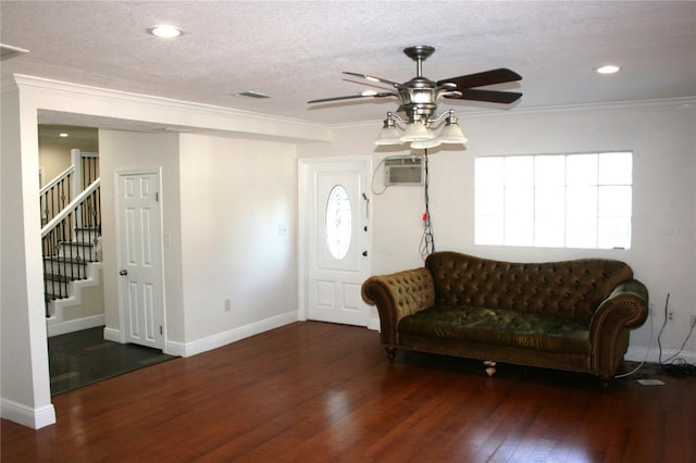 foyer featuring ceiling fan, a textured ceiling, dark hardwood / wood-style flooring, and crown molding