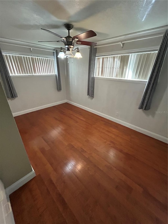 spare room featuring dark hardwood / wood-style floors and ceiling fan