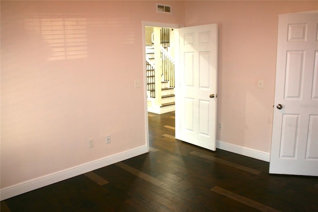 unfurnished bedroom featuring dark hardwood / wood-style floors