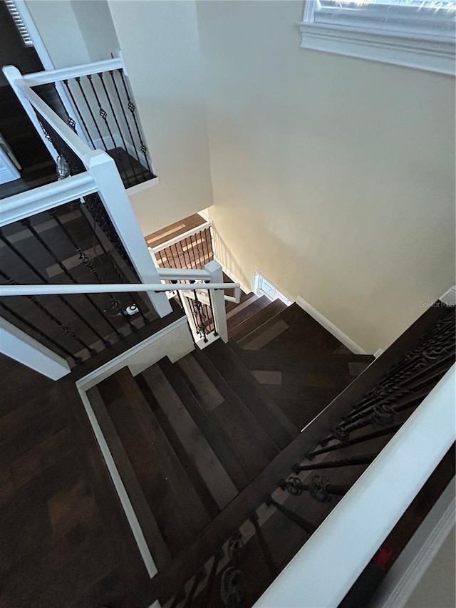 stairs with hardwood / wood-style flooring