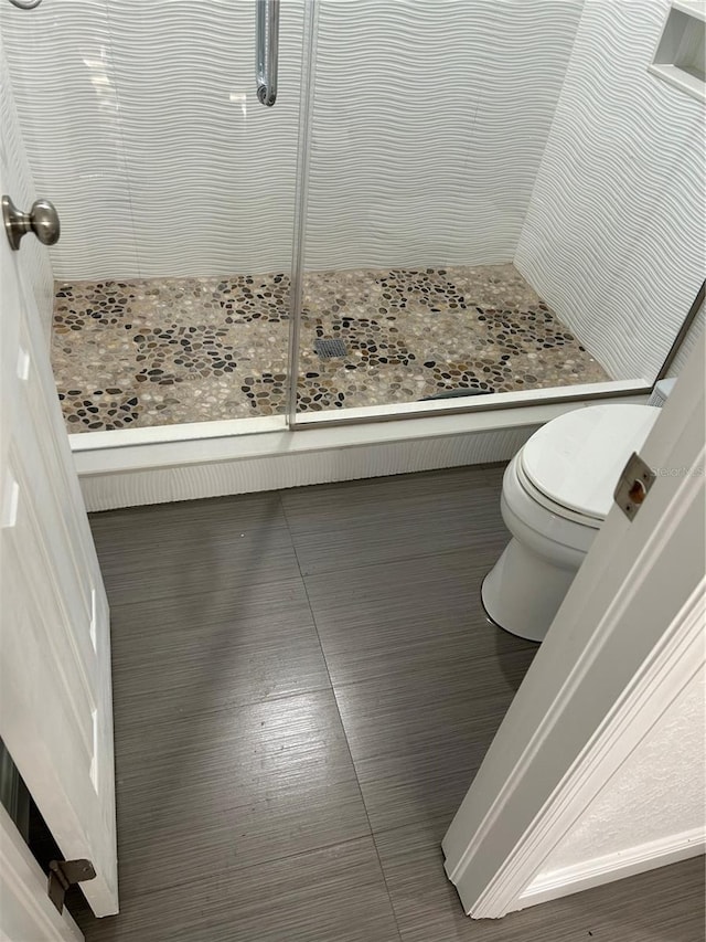 bathroom with toilet and walk in shower