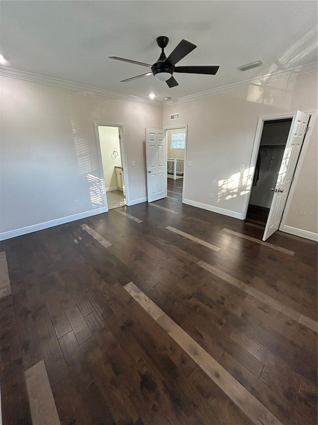 unfurnished bedroom featuring crown molding, ensuite bath, ceiling fan, and dark hardwood / wood-style flooring