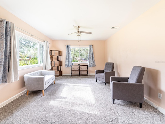 living area featuring ceiling fan