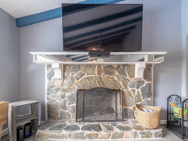 interior details with beamed ceiling and a fireplace