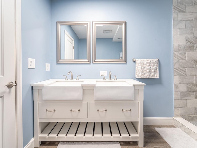 bathroom featuring vanity, hardwood / wood-style flooring, and a shower