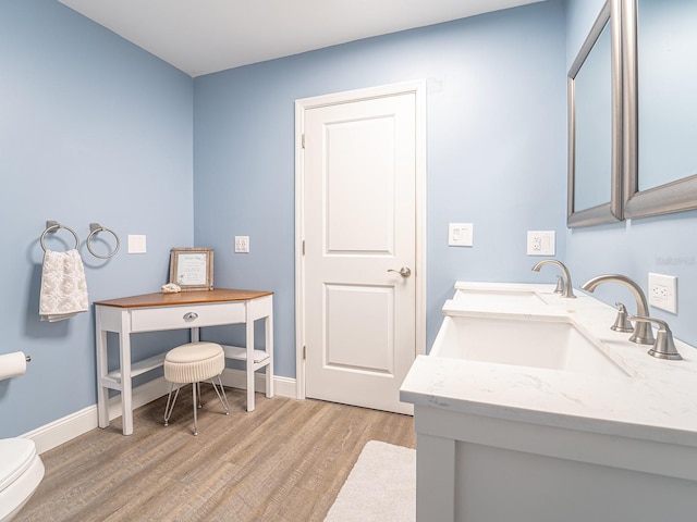 bathroom featuring sink, toilet, and hardwood / wood-style floors