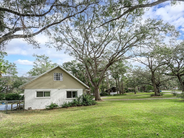 view of property exterior with a yard