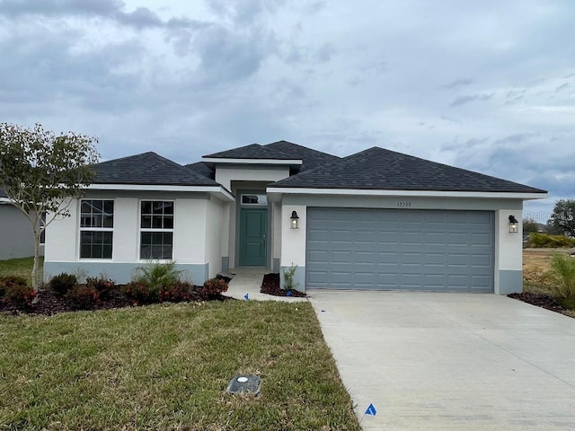 view of front of home featuring a front yard and a garage