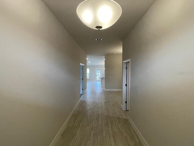 corridor featuring hardwood / wood-style floors