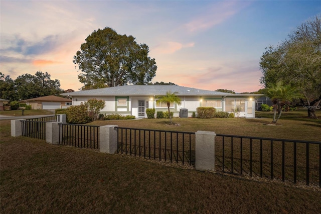 single story home with a lawn and a garage