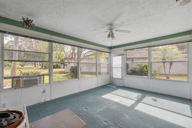 unfurnished sunroom featuring ceiling fan and cooling unit