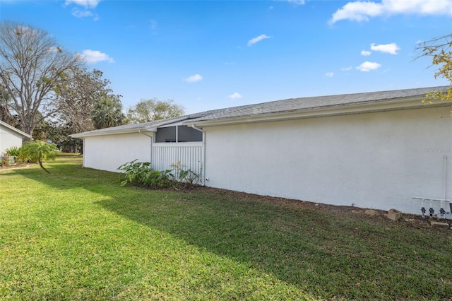 view of property exterior with a yard