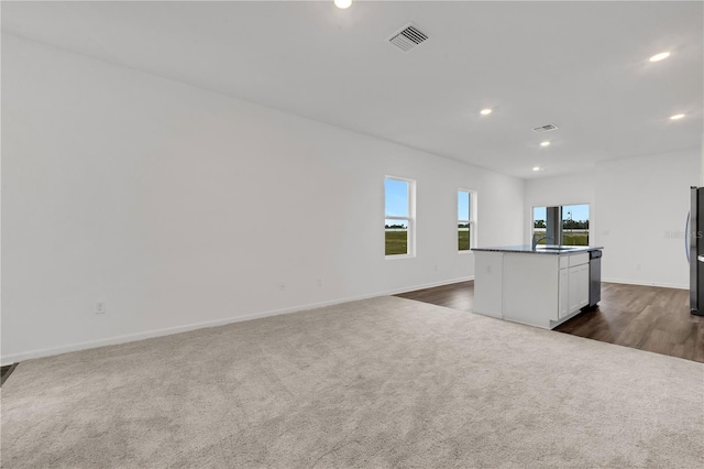 unfurnished living room with sink and dark carpet