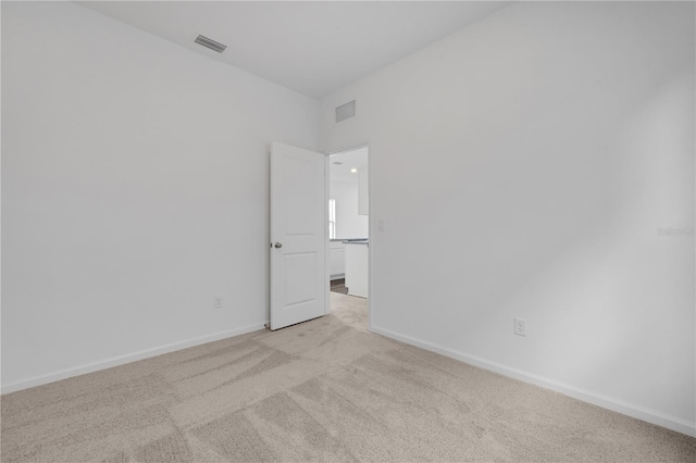 unfurnished room with light carpet